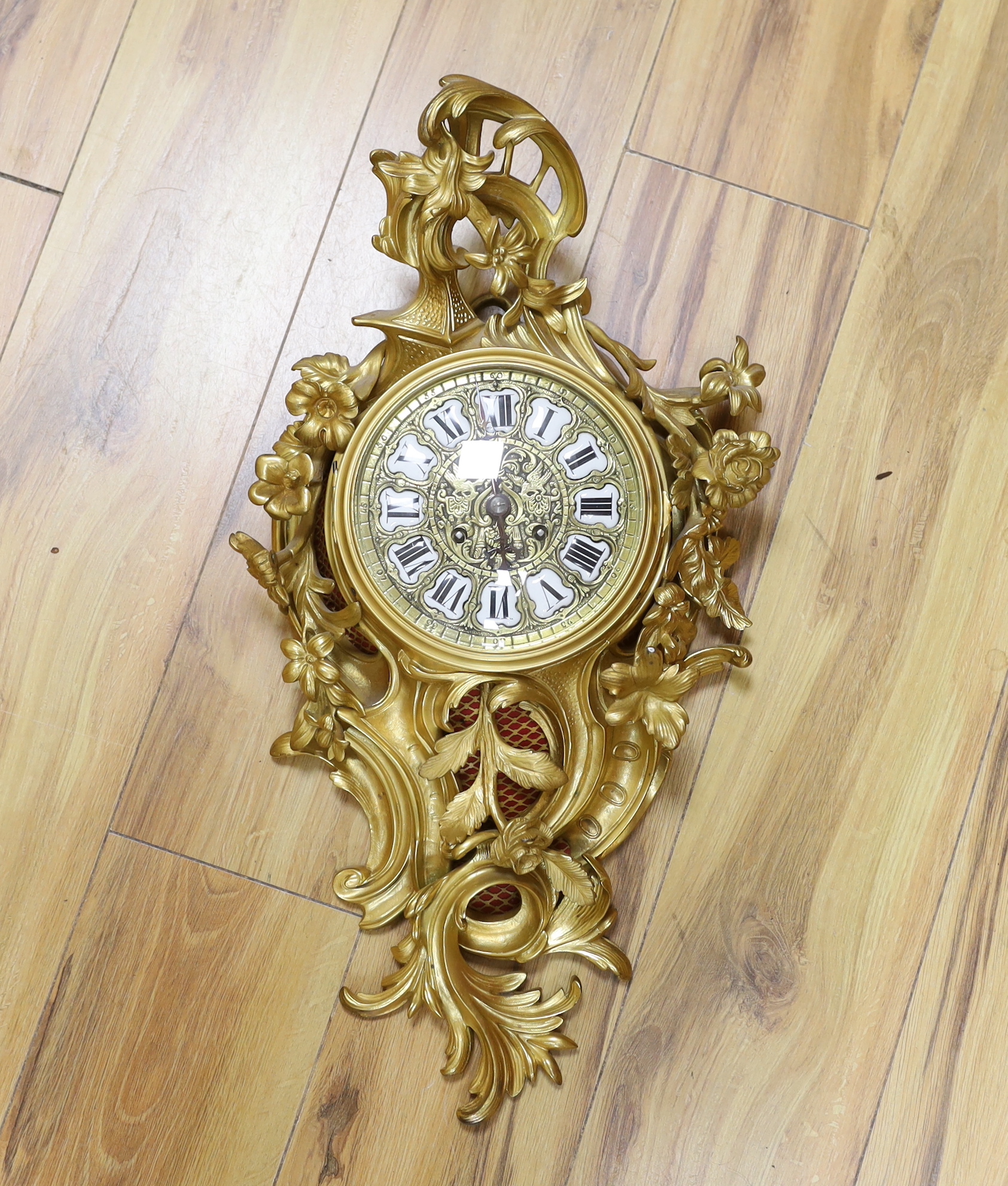 A Louis XV style gilt metal Cartel clock striking on a bell, 58cm